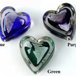 Three different colors of glass hearts are shown.