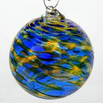 A blue and yellow glass ball hanging from a silver chain.