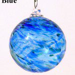 A blue glass ball hanging from a chain.