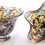 Two glass bowls are sitting on a table.