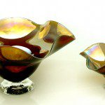 A pair of glass bowls with brown and yellow designs.