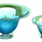 Two blue bowls are sitting on a table.