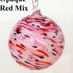 A pink and red glass ornament hanging from a hook.