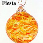 A glass ornament with orange and yellow swirls.