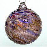 A glass ornament with purple and brown swirls.