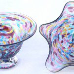 A pair of bowls with colorful designs on them.