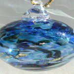 A blue glass ornament with gold accents.