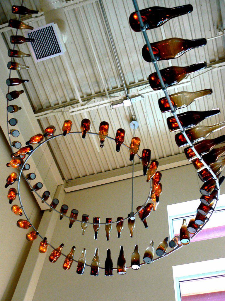 A spiral of bottles hanging from the ceiling.