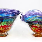 Two bowls are shown side by side, one of which has a rainbow design.