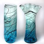 Two blue vases with black lines on them.