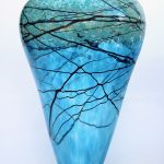 A blue vase with branches on it