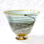 A glass bowl with branches on it