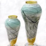A pair of vases with yellow and blue designs.