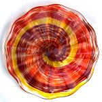 A red and yellow glass dish on top of a table.