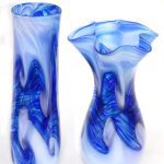 Two blue vases with a white background