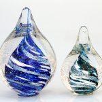 Two glass vases with a blue swirl design on them.