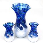 A set of three vases with blue and white swirls.